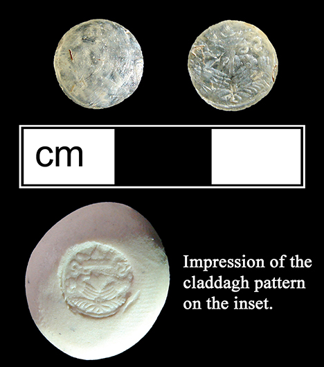 Colorless glass sleeve link inset with a claddagh pattern molded into the back